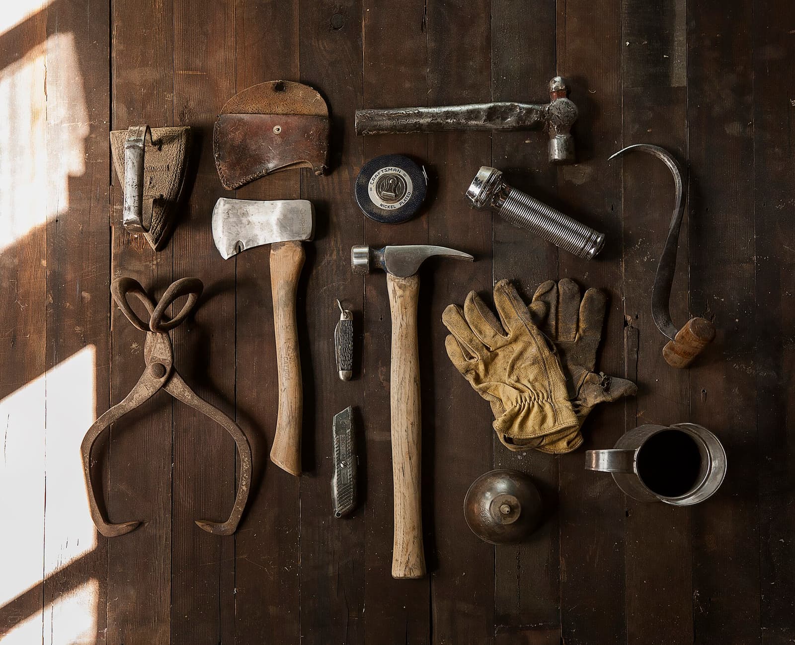 Hand tools laid out on a wooden floor