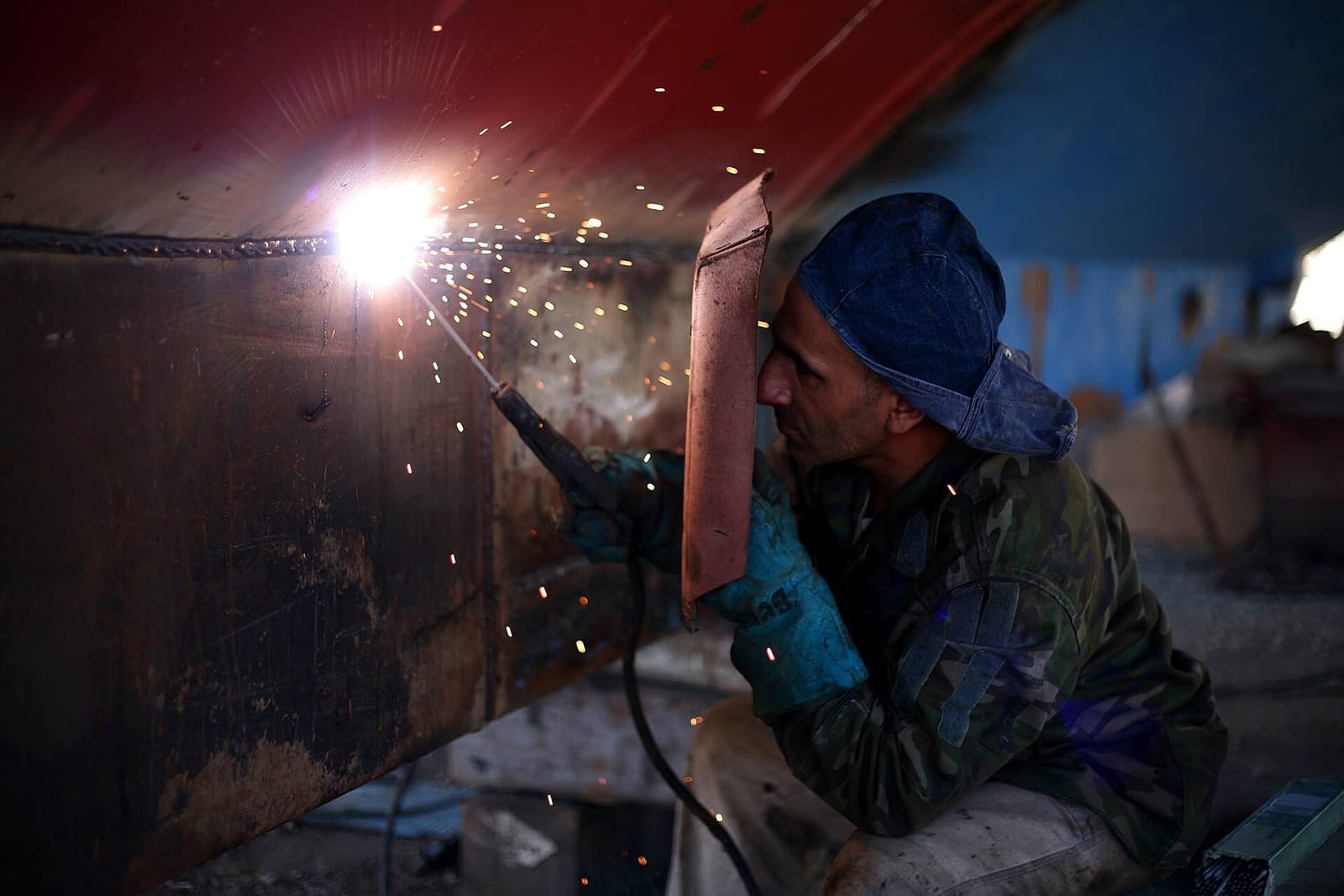 A welder at work in a shower of sparks